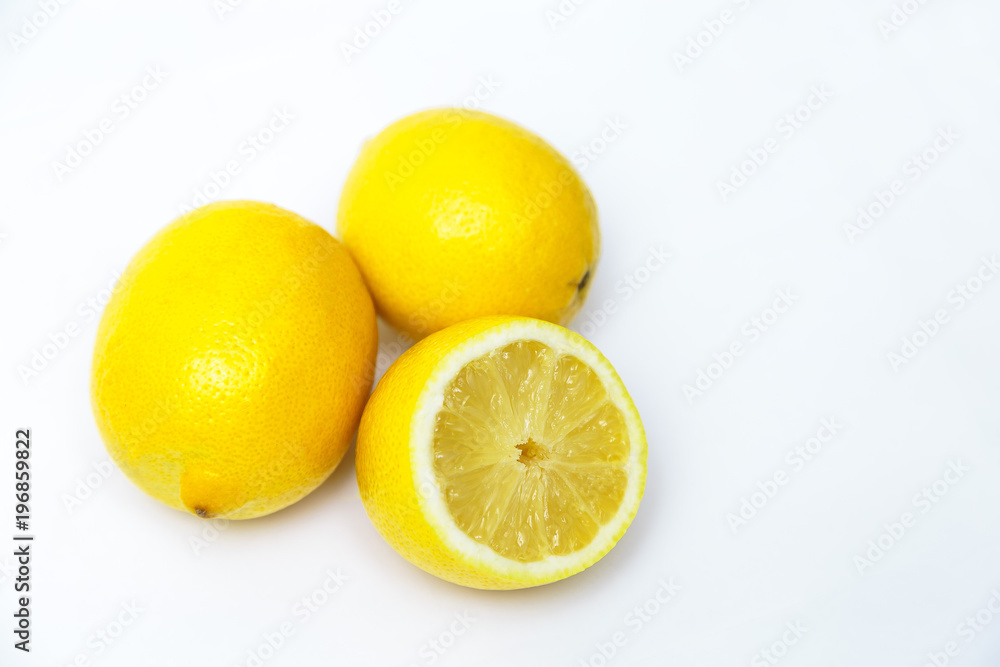 three yellow lemon one in a cut on a white background three yellow lemon one in a cut on a white background