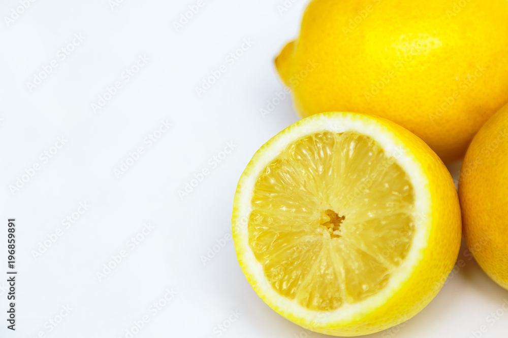 three yellow lemon one in a cut on a white background three yellow lemon one in a cut on a white background
