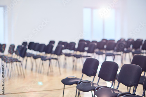 Rows of empty chairs in contemporary conference hall or large auditorium