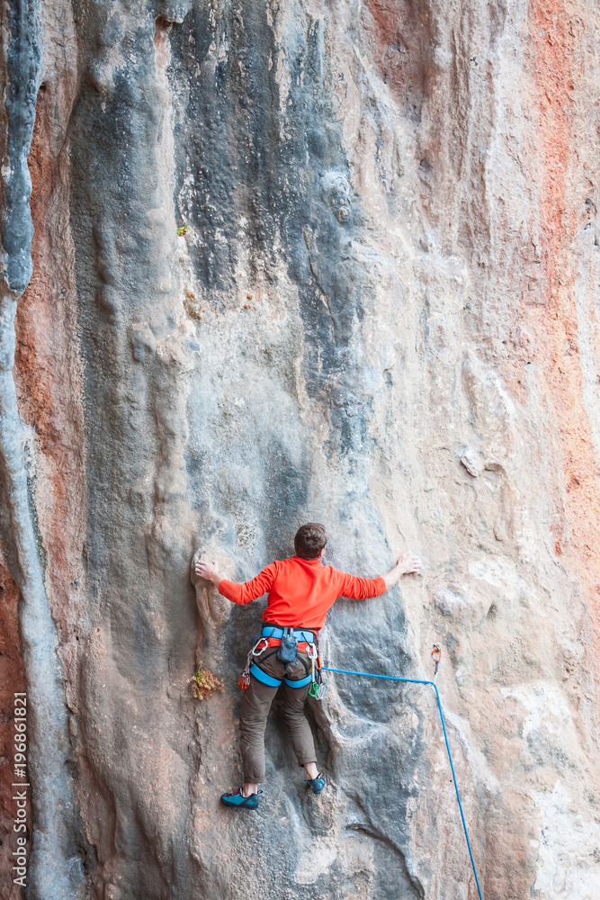 A man climbs the rock. A man climbs the rock.