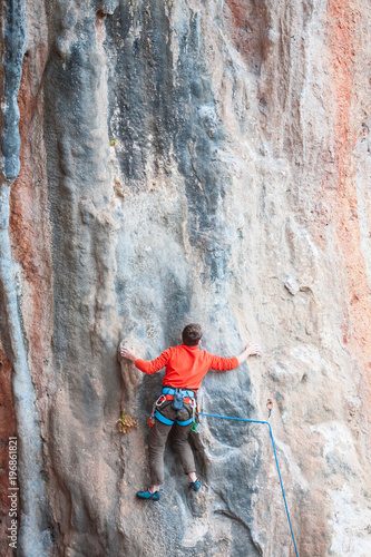 A man climbs the rock.