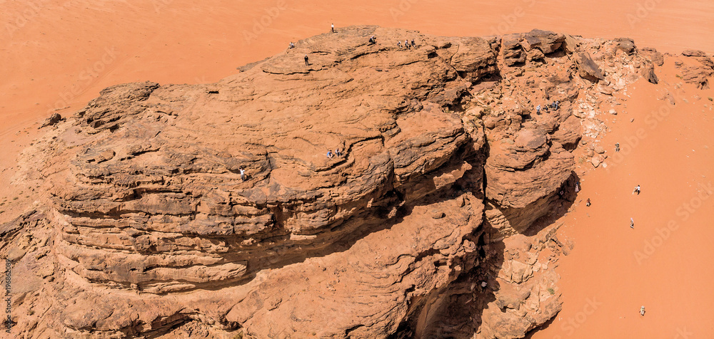 Aerial view, taken with the drone, of rock formations and monolithic mountains in the desert of Wadi Rum, Jordan Aerial view, taken with the drone, of rock formations and monolithic mountains in the desert of Wadi Rum, Jordan