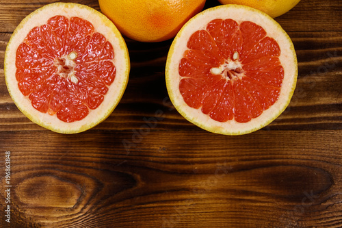 Ripe fresh grapefruits on wooden table