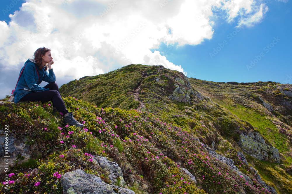 The girl enjoys landscapes in the mountains of the Carpathians.