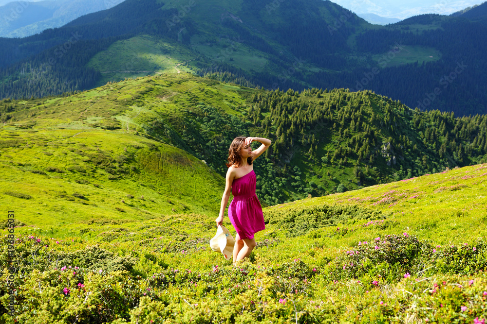 The girl enjoys landscapes in the mountains of the Carpathians. The girl enjoys landscapes in the mountains of the Carpathians.