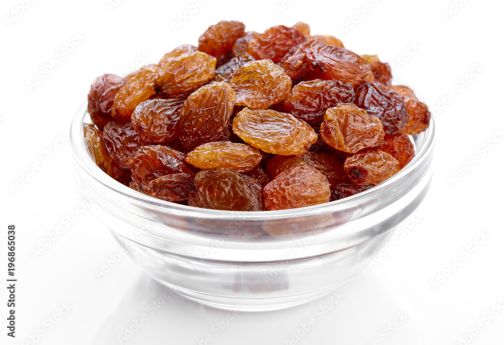 bowl of raisins on a white background. Dried grapes. bowl of raisins on a white background. Dried grapes.