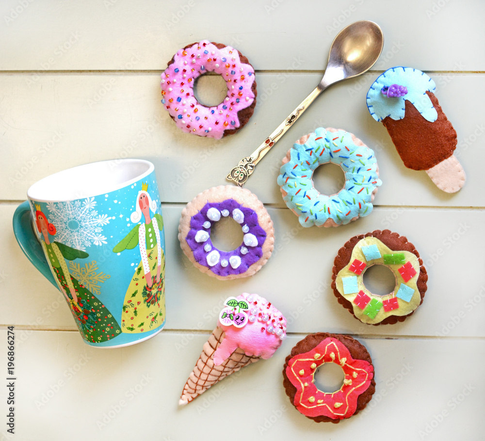 Donuts and ice cream is sewed from felt for a children's game in a shop or cafe