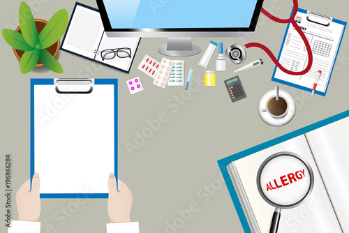 Top view of a medical table with doctor accessories. Doctor is holding blank paper ready for your text. The magnifying glass magnifies the inscription Allergy in an open book.