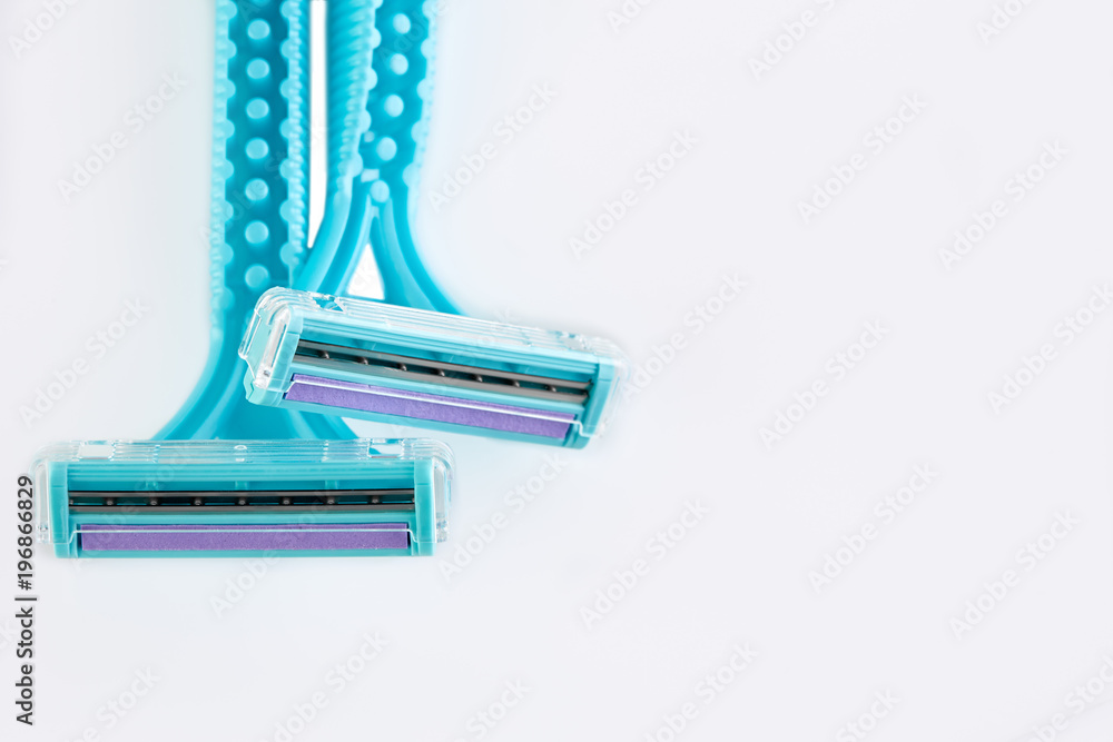 Blue female razors isolated on the white background. Razor for female shaving. Blue female razors isolated on the white background. Razor for female shaving.