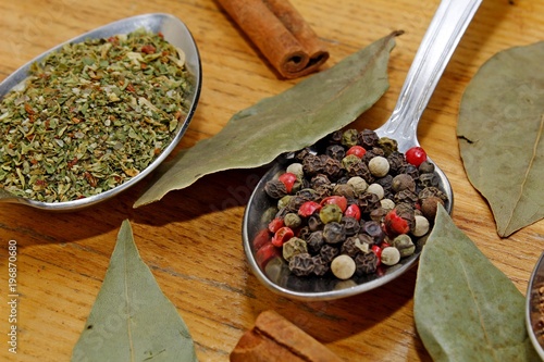 Fototapeta Naklejka Na Ścianę i Meble -  Spices in spoons on a wooden table