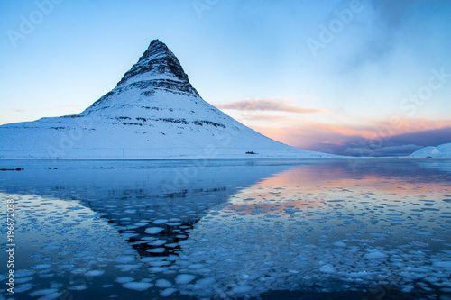 Kirkjufell is a beautifully shaped and a symmetric, free standing mountain in Iceland