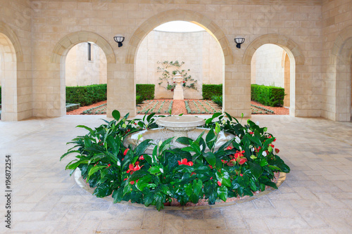 The fountain surrounded by flowers in the temple of Bahai in Acre, Israel. photo