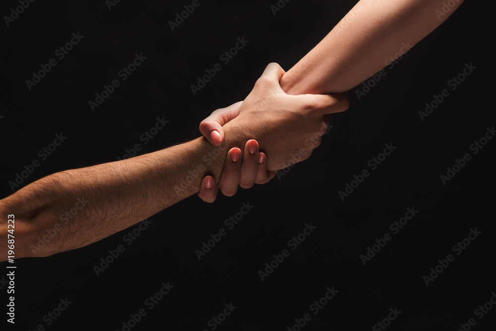 Hands of man and woman in love, isolated on black Hands of man and woman in love, isolated on black