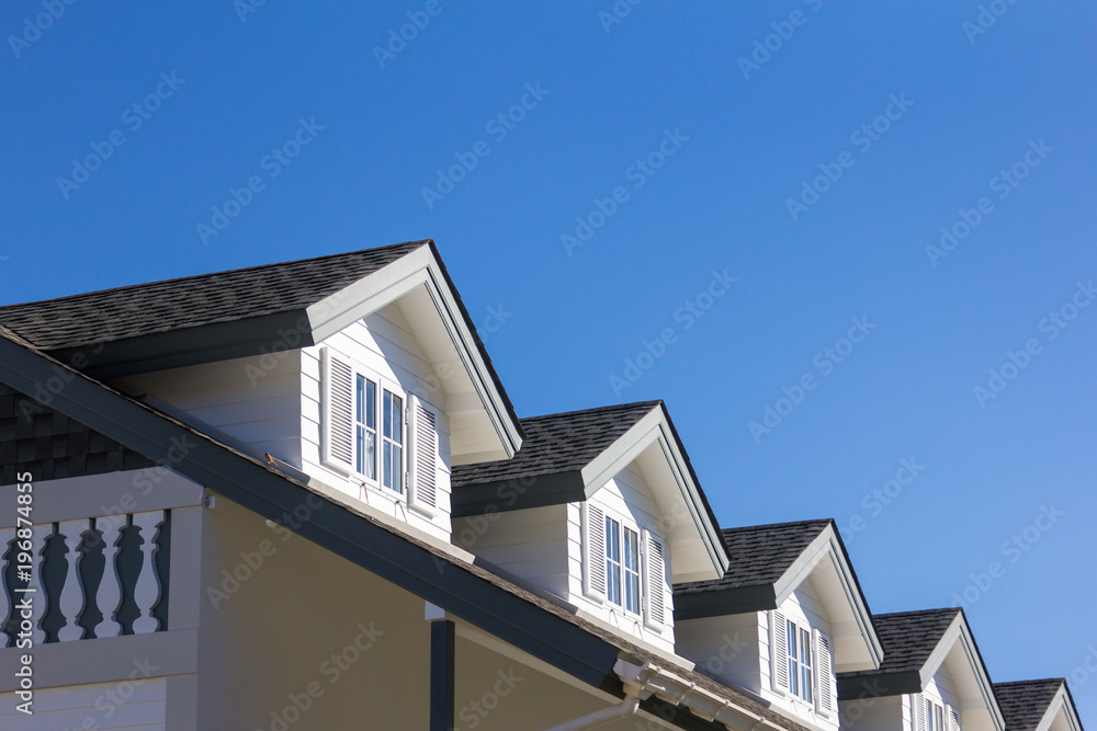 The roof of the house with beautiful window in the blue sky background. The roof of the house with beautiful window in the blue sky background.