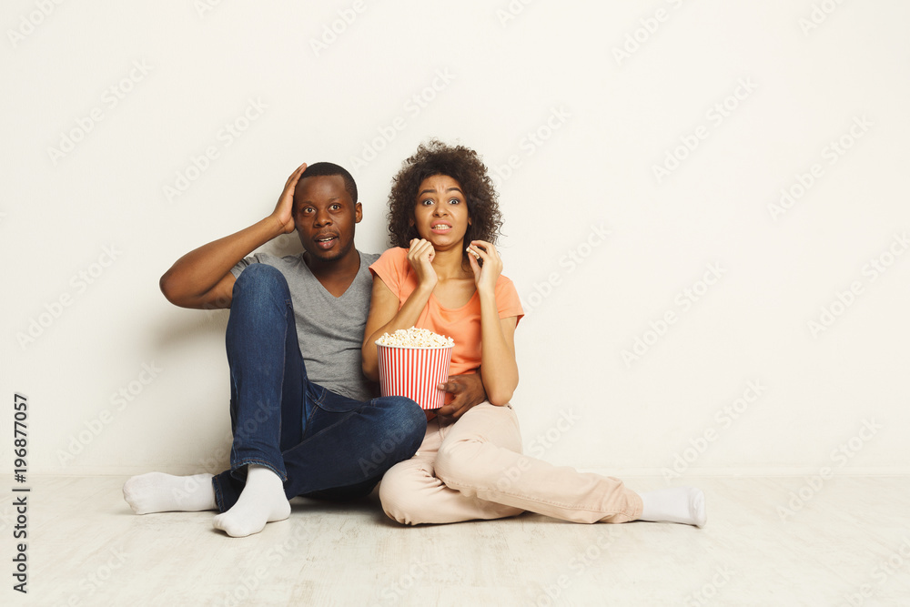 Black couple wathing scary movie at home Black couple wathing scary movie at home