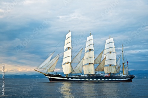 Tall ship race in the Black sea. Large white sails on masts. Beauty seascape.