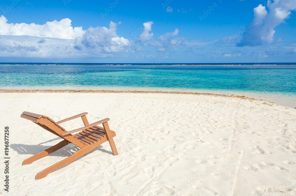 Relaxing on chair - South Water Caye - Small tropical island at Barrier Reef with paradise beach - known for diving, snorkeling and relaxing vacations - Caribbean Sea, Belize, Central America Relaxing on chair - South Water Caye - Small tropical island at Barrier Reef with paradise beach - known for diving, snorkeling and relaxing vacations - Caribbean Sea, Belize, Central America