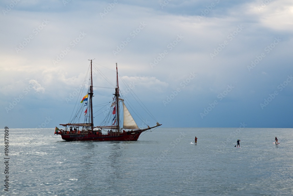 Tall ship race in the Black sea. Large white sails on masts. Beauty seascape.