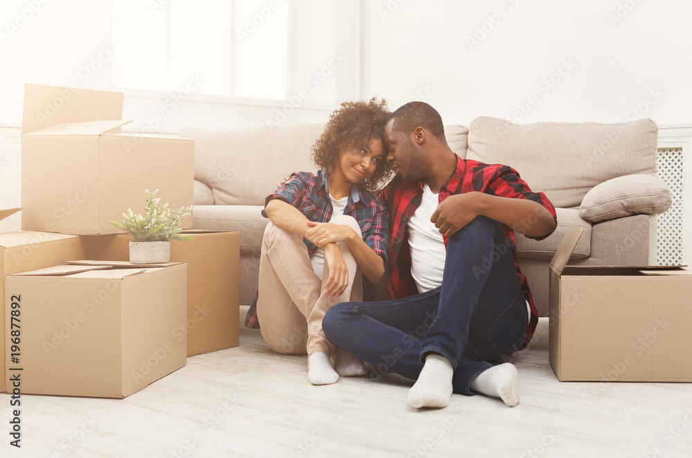 Young balck couple unpacking moving boxes Young balck couple unpacking moving boxes