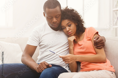 Sad black couple after pregnancy test result photo