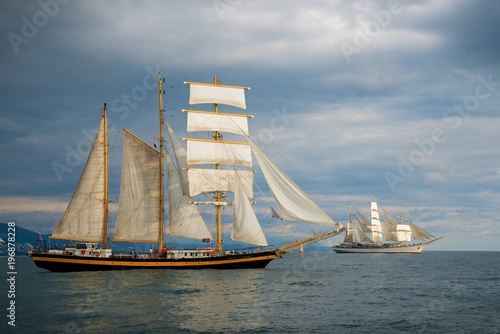 Tall ship race in the Black sea. Large white sails on masts. Beauty seascape.