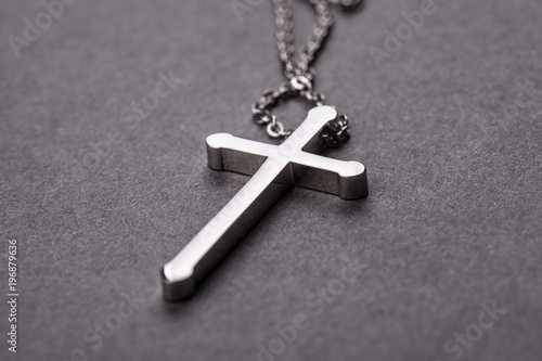 Silver cross on a gray background