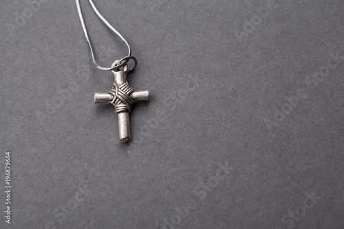 Silver cross on a gray background