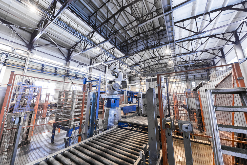 Fototapeta premium Factory workshop interior and machines on glass production background