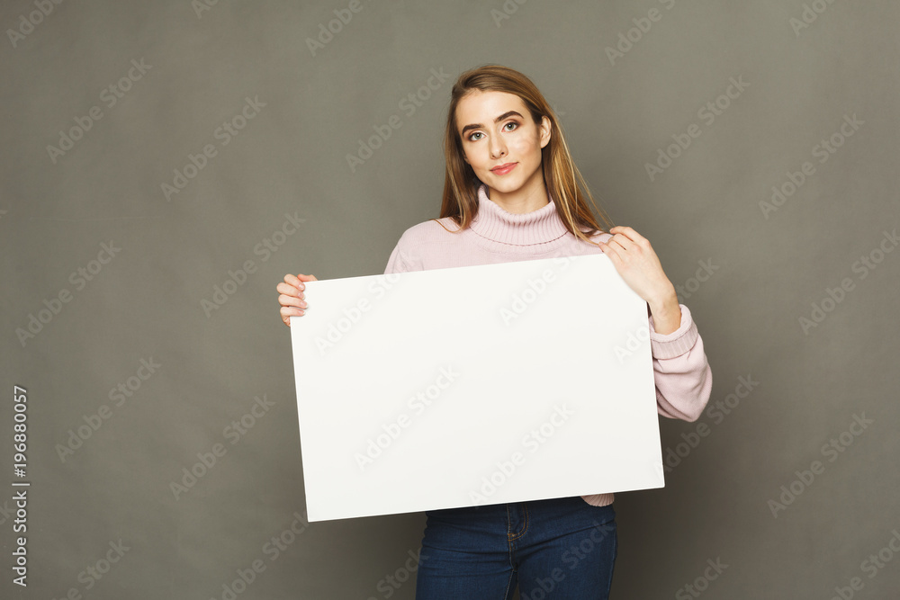 Young smiling woman with blank white paper