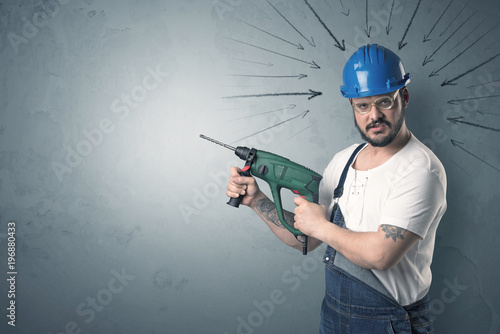 Worker standing with tool.
