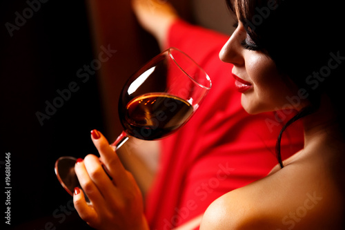 The image of the girl with the red lips, fault holding a glass.