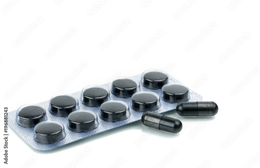 Capsules and tablets pills of activated charcoal in blister pack isolated on white background Capsules and tablets pills of activated charcoal in blister pack isolated on white background