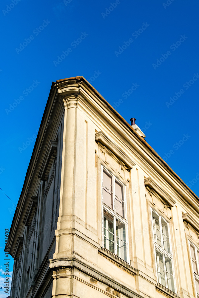 Architectural detail. Corner house detail, clear blue sky in background.