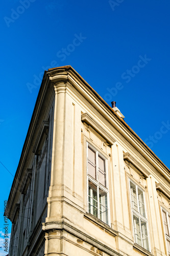 Architectural detail. Corner house detail, clear blue sky in background.