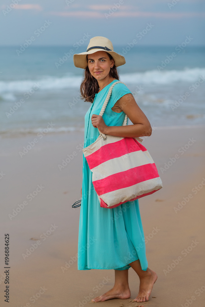Woman at the seashore of Indian ocean on a cloudy day