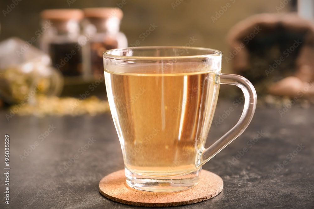 Glass cup of aromatic tea on table Glass cup of aromatic tea on table