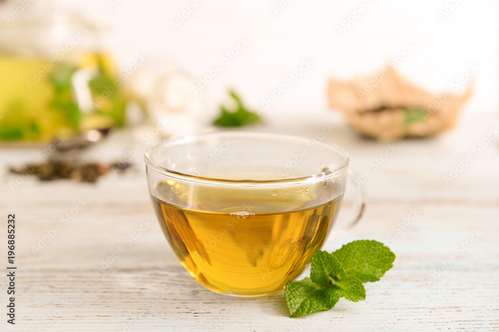 Glass cup of aromatic tea on table Glass cup of aromatic tea on table