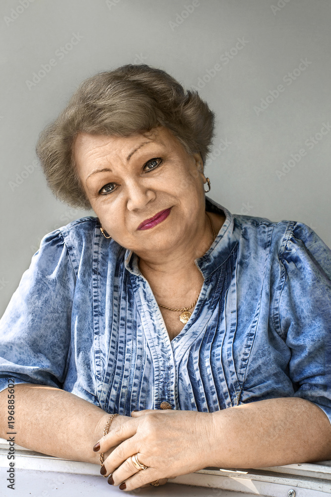 An elderly woman is looking at you attentively An elderly woman is looking at you attentively