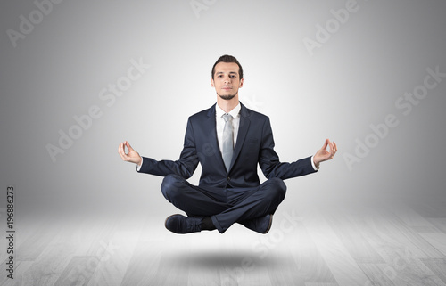 Businessman meditates in an empty space concept