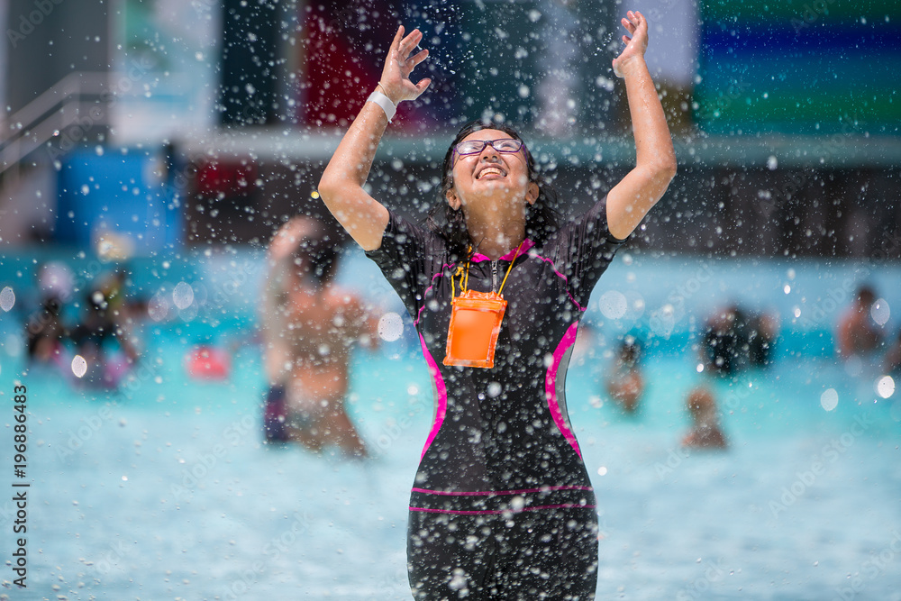 Asian woman fun and enjoy swimming at water park Asian woman fun and enjoy swimming at water park