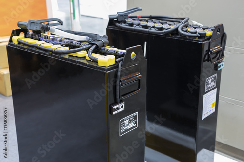 Industrial battery  is a device consisting of electro-chemical cells with external connections provided to power electrical for forklift/vehicle  / automotive  ; close up ; industrial background