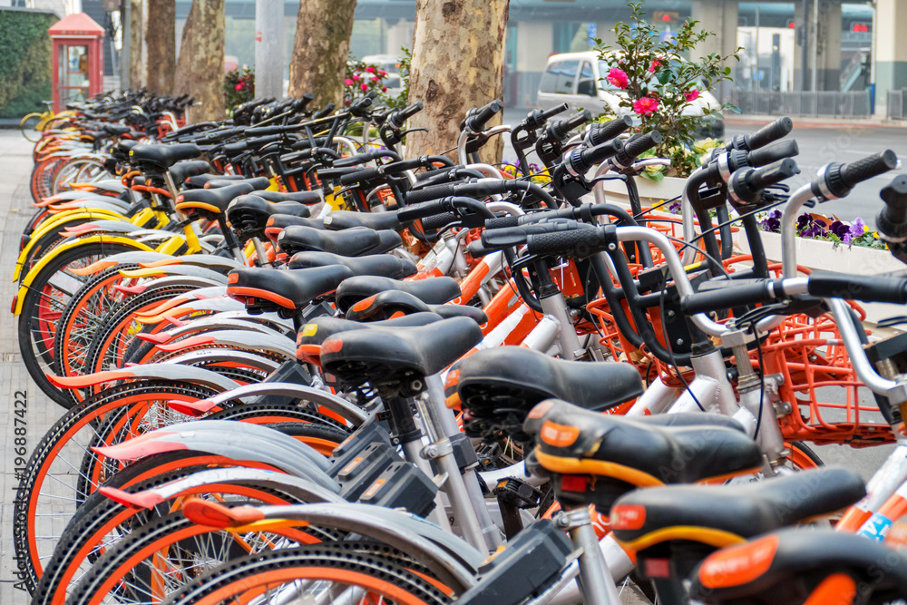 Bike rental service. Many olors bikes in a city context Bike rental service. Many olors bikes in a city context
