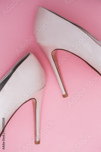 stylish pink shoes on pink background