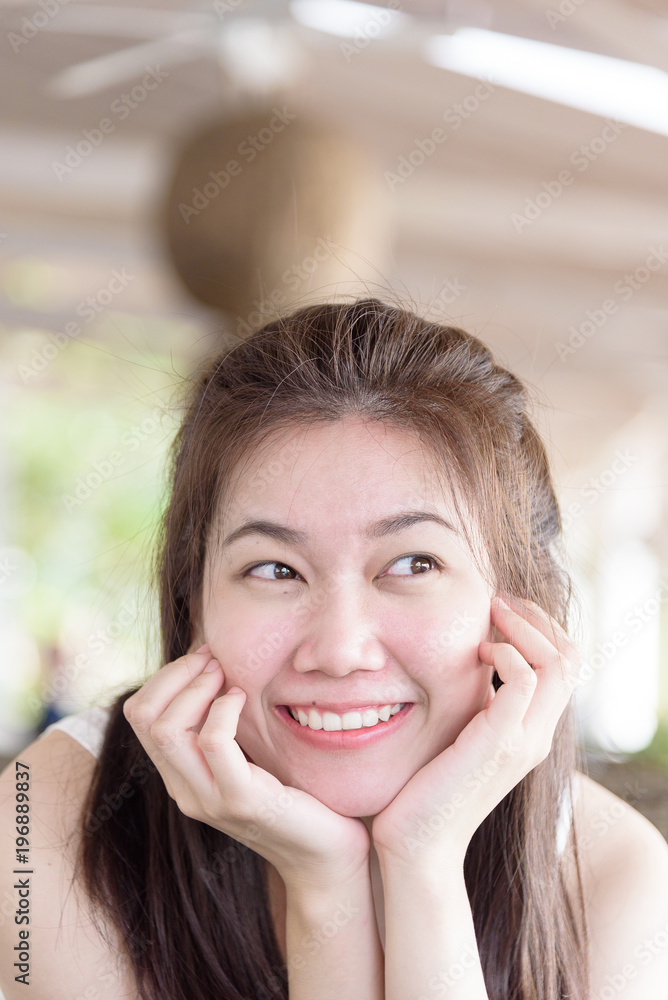Beautiful asian woman has happy and laughing in the bar and restaurant for dinner in the evening and sun lighting with relaxing and vacation time.