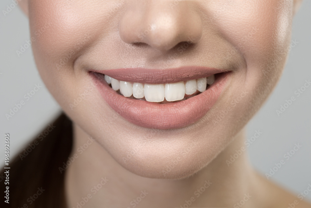 Close up of wide smile of happy young woman. She is demonstrating her white healthy teeth. Oral care concept Close up of wide smile of happy young woman. She is demonstrating her white healthy teeth. Oral care concept