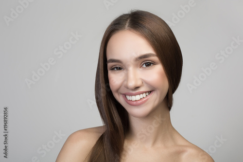 Great mood. Portrait of cheerful attractive young naked woman is looking at camera with joy. Isolated background. Haircare and natural beauty concept