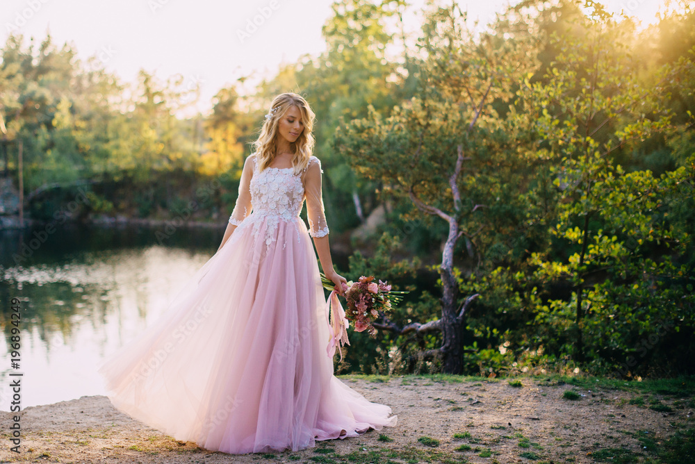 portrait of a young beautiful bride in the sun on a nature background portrait of a young beautiful bride in the sun on a nature background