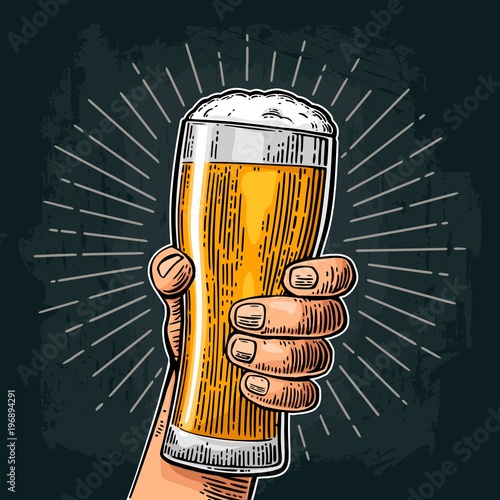 Male hand holding beer glass. Born to drink beer