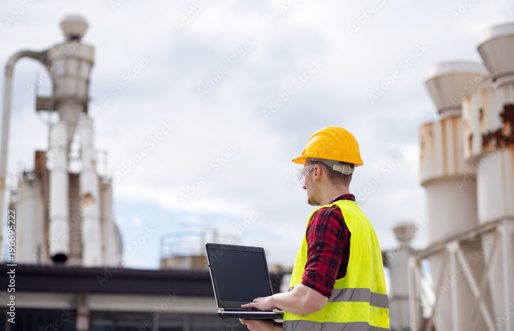 Industrial worker using laptop Industrial worker using laptop
