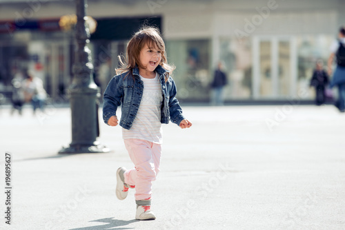 Portrait of happy child playing outdoors.